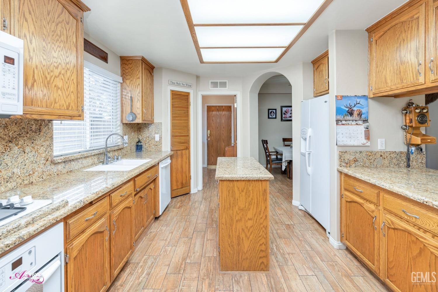 Undisclosed Address Bakersfield, CA 93312 - Photo 11 of 26 a large kitchen with stainless steel appliances granite countertop a lot of counter space and wooden floors