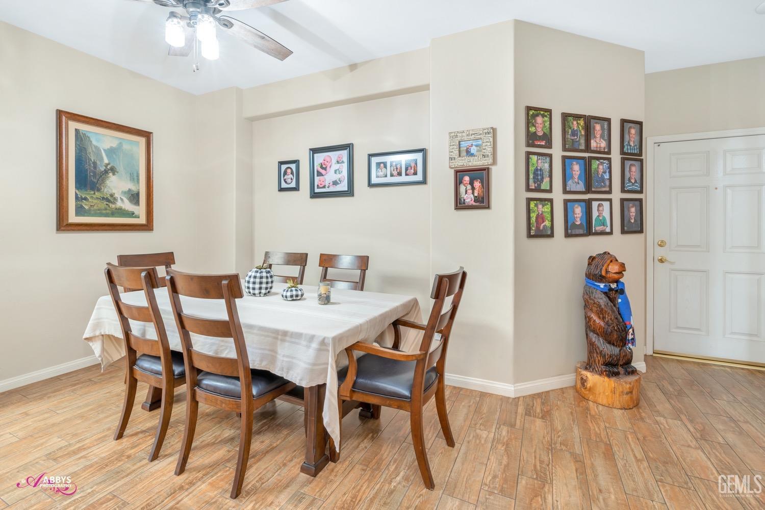 Undisclosed Address Bakersfield, CA 93312 - Photo 13 of 26 a view of a dining room with furniture and wooden floor