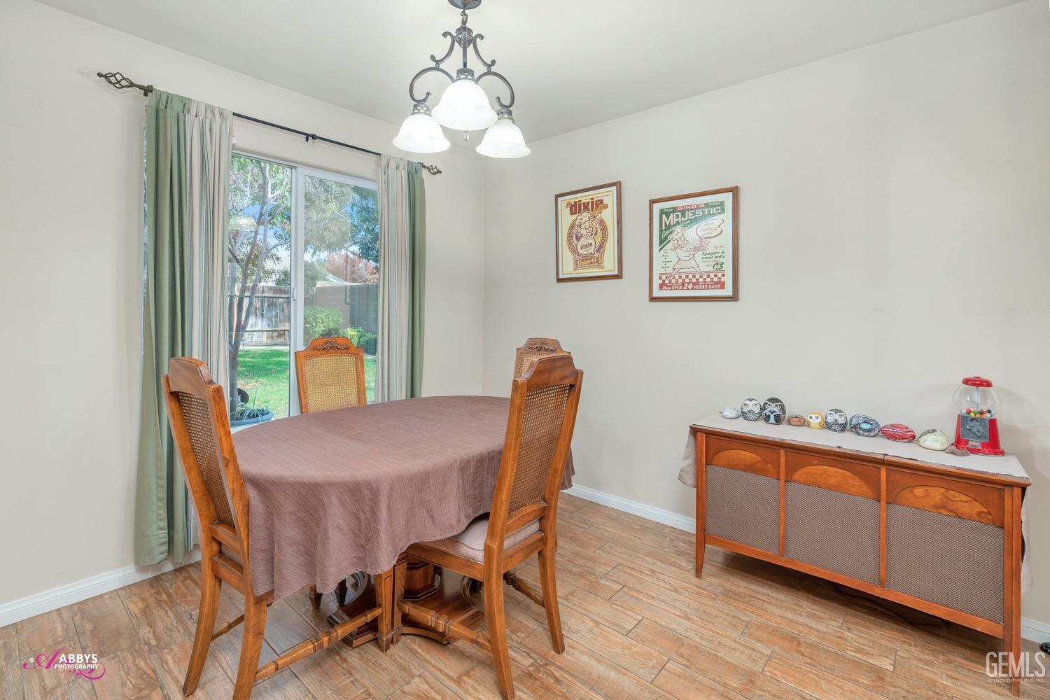 Undisclosed Address Bakersfield, CA 93312 - Photo 15 of 26 a dining room with furniture a chandelier and wooden floor