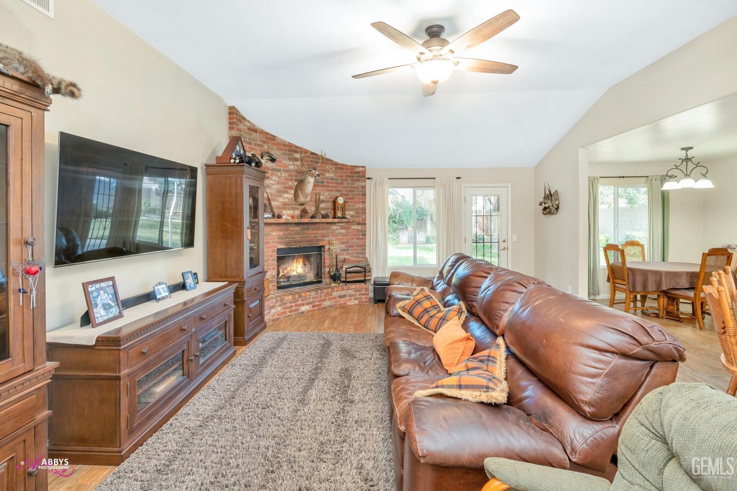 Undisclosed Address Bakersfield, CA 93312 - Photo 16 of 26 a living room with furniture a flat screen tv and a fireplace