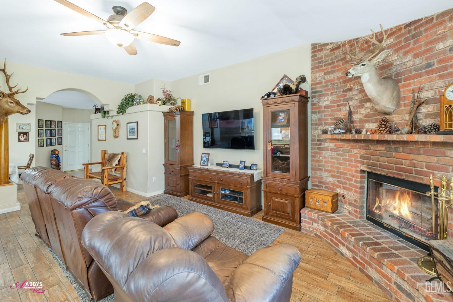 Undisclosed Address Bakersfield, CA 93312 - Photo 17 of 26 a living room with furniture and a fireplace