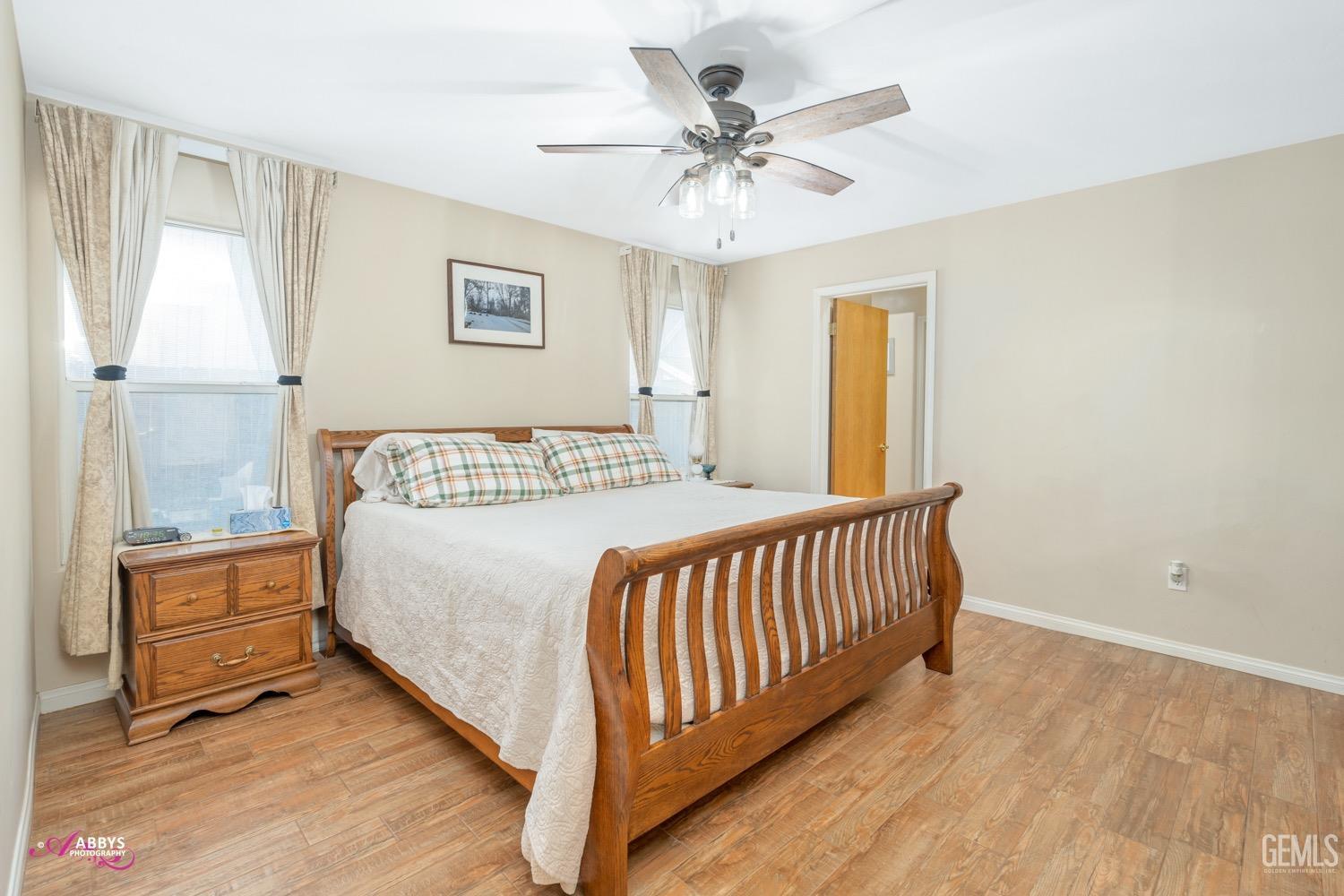 Undisclosed Address Bakersfield, CA 93312 - Photo 18 of 26 a bedroom with a bed and a chandelier