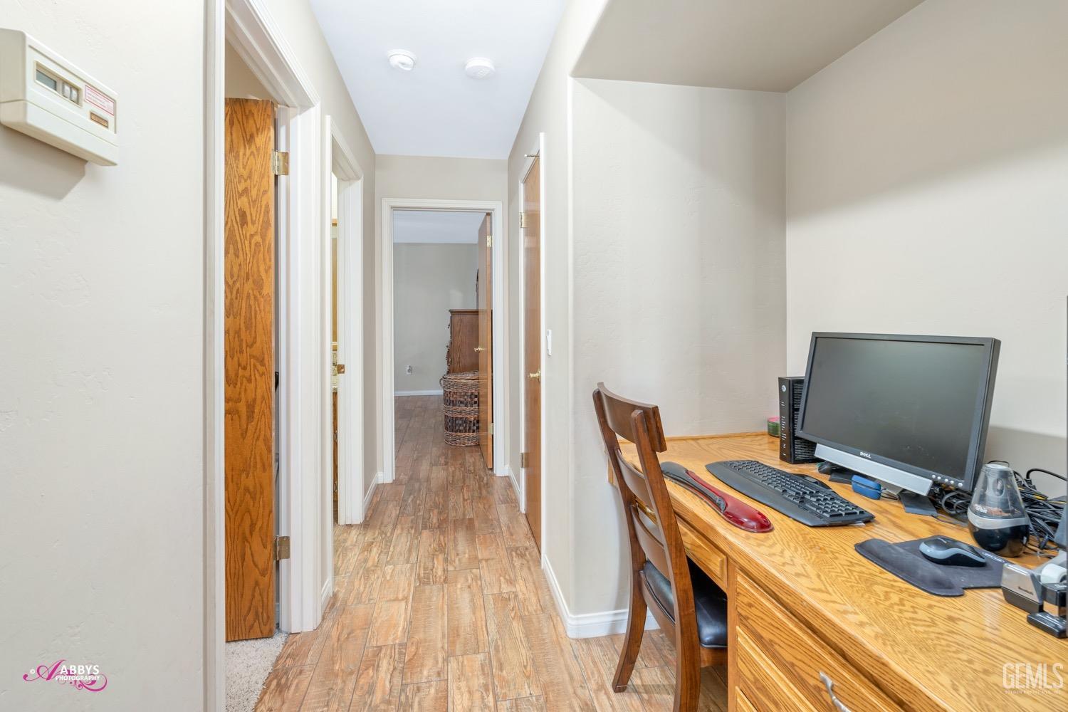 Undisclosed Address Bakersfield, CA 93312 - Photo 24 of 26 a view of a workspace with furniture and wooden floor