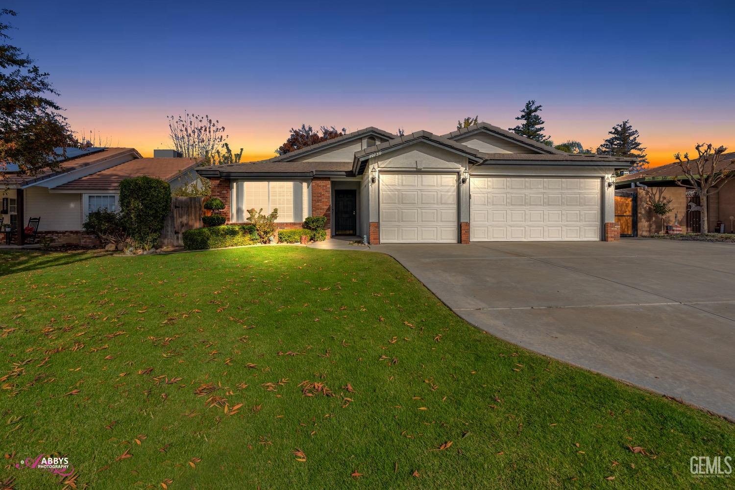Undisclosed Address Bakersfield, CA 93312 - Photo 26 of 26 a front view of a house with a yard and garage