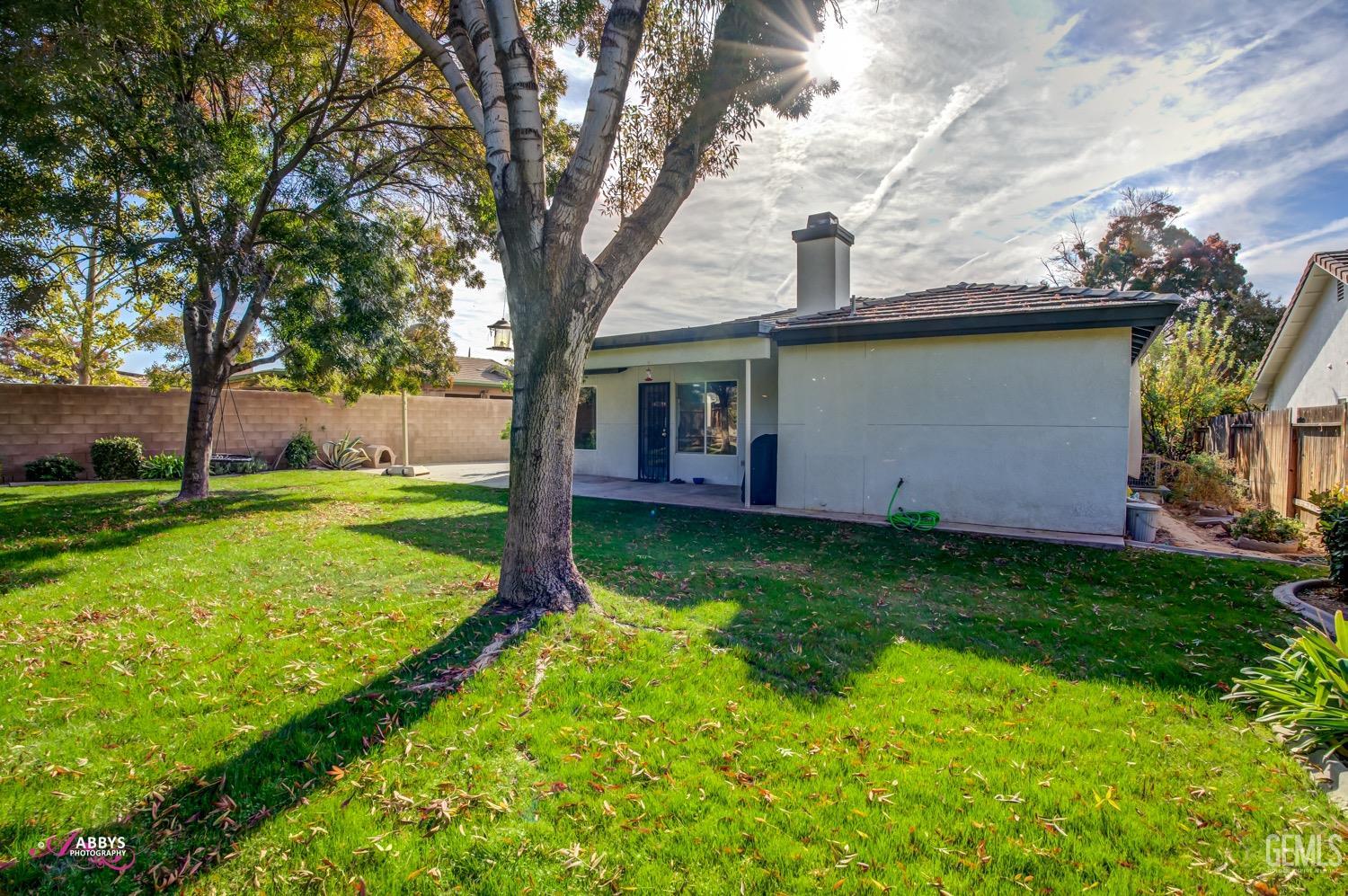 Undisclosed Address Bakersfield, CA 93312 - Photo 6 of 26 a view of a house with backyard and garden