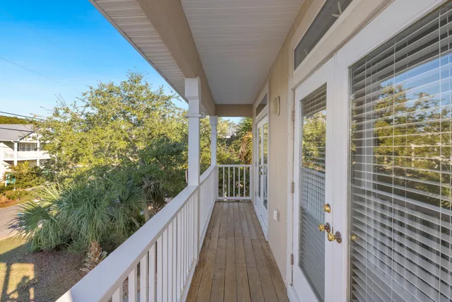 a view of a balcony with wooden floor