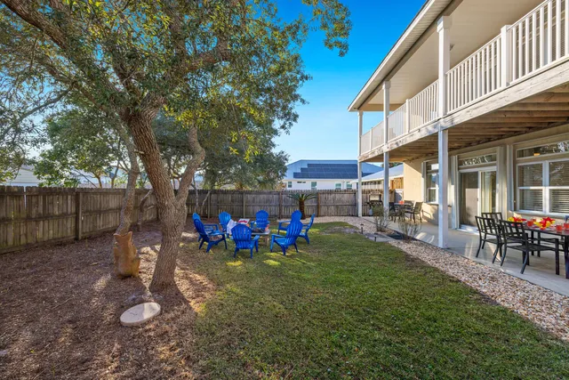 a view of a chairs in patio with wooden fence