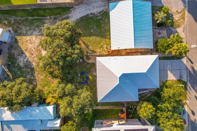 an aerial view of a house with yard swimming pool and outdoor seating