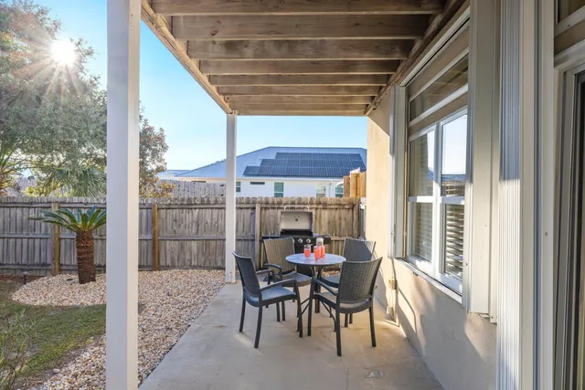a view of a porch with furniture and a yard