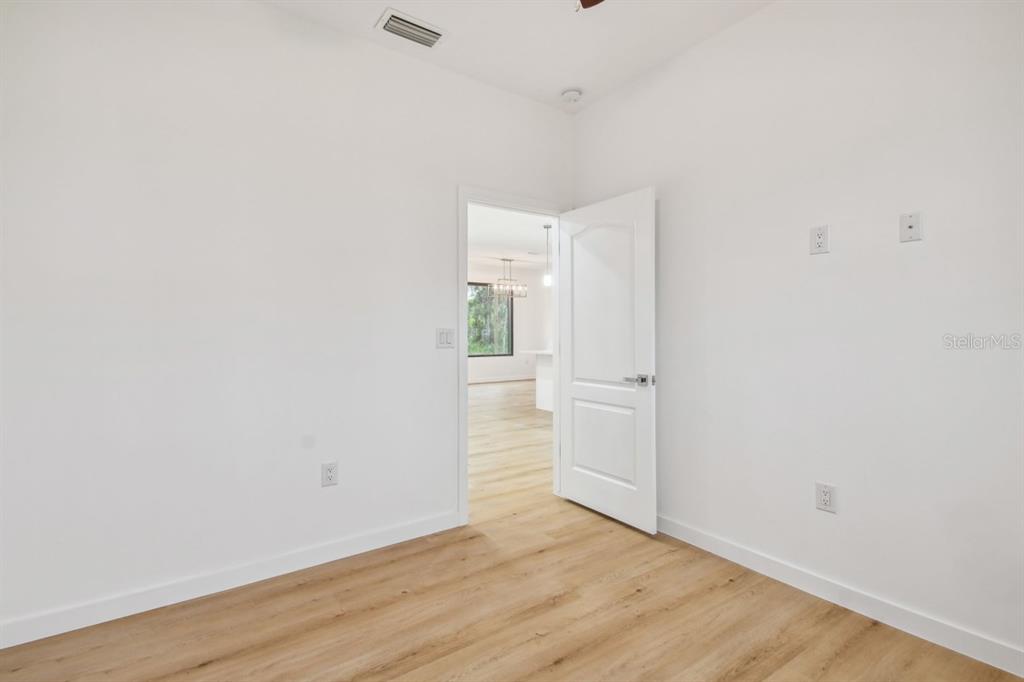 406 Border Street Port Charlotte, FL 33953 - Photo 11 of 20 a view of an empty room with wooden floor