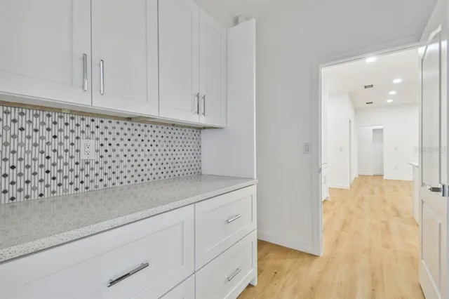 a bathroom with a toilet a sink a mirror and a shower