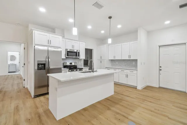 a view of a kitchen island a sink and dishwasher