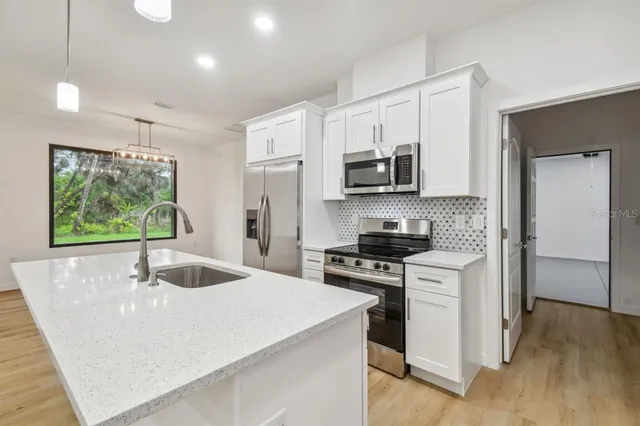 a kitchen with a sink and cabinets