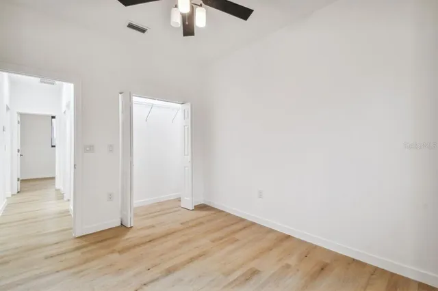 a view of an empty room with wooden floor