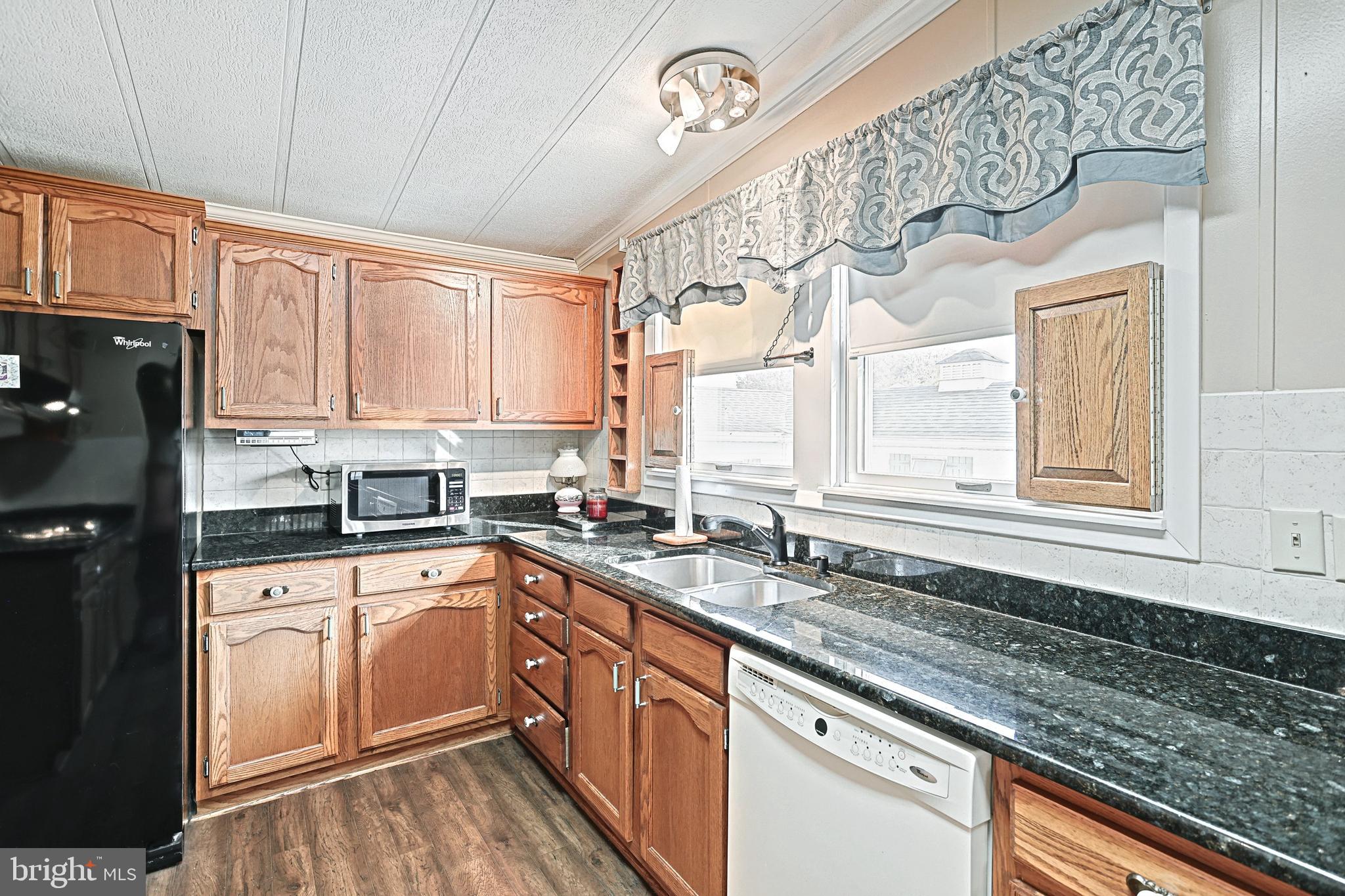 95 Sechrist Flat Road Felton, PA 17322 - Photo 11 of 45 a kitchen with stainless steel appliances granite countertop a sink a stove cabinets counter space and a window