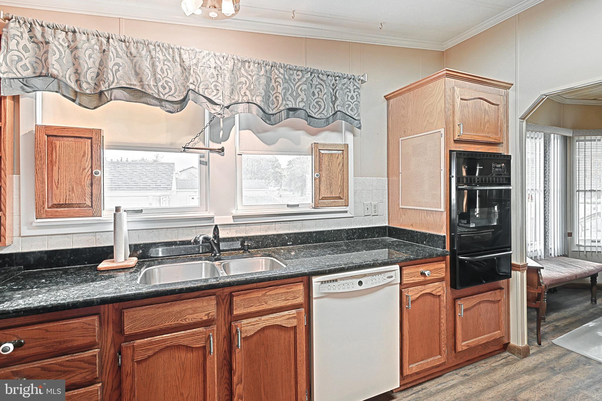 95 Sechrist Flat Road Felton, PA 17322 - Photo 12 of 45 a kitchen with stainless steel appliances granite countertop a sink and a granite counter tops with wooden floors