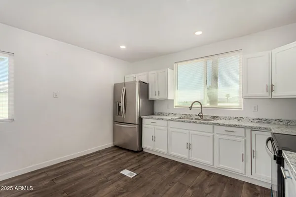a kitchen with appliances cabinets and a sink