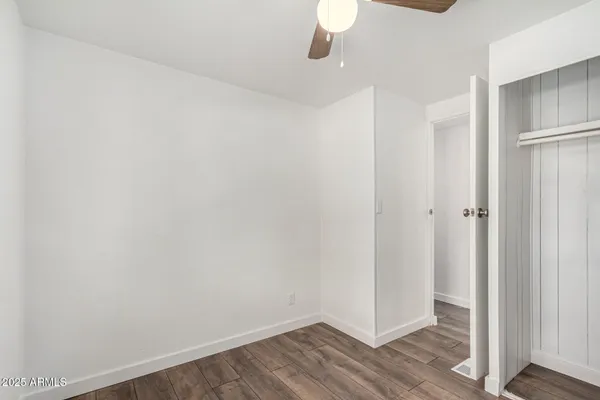 a view of a room with wooden floor
