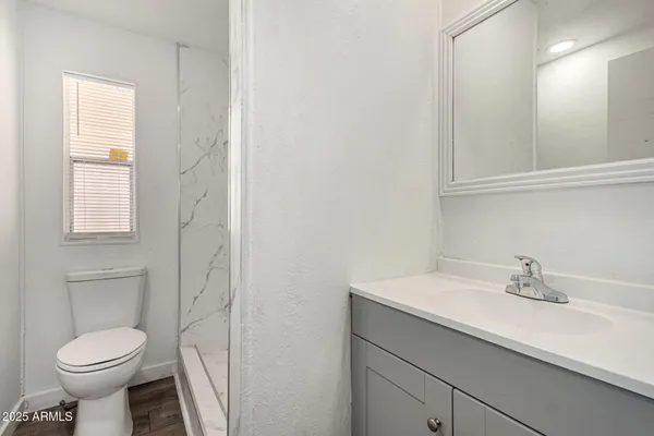 a bathroom with a sink toilet and a mirror