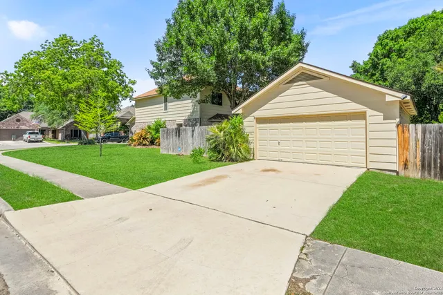 a view of backyard of house and garage