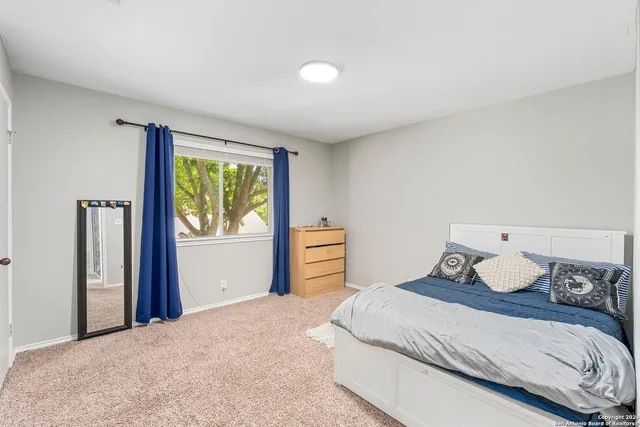 a bedroom with a bed and window