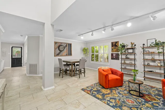 a living room with furniture a rug and a window