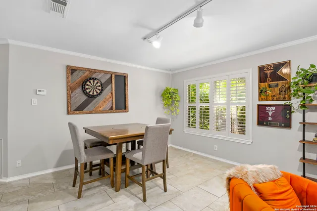 a dining room with furniture and a window