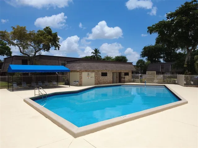 a view of a swimming pool and a yard