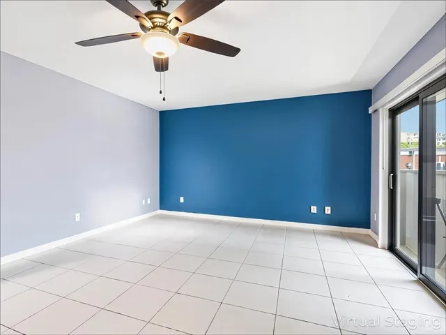 an empty room with fan and windows