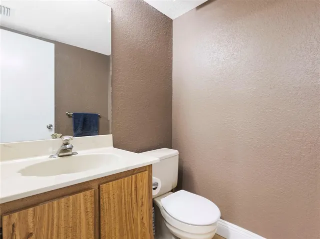 a bathroom with a sink a toilet and mirror