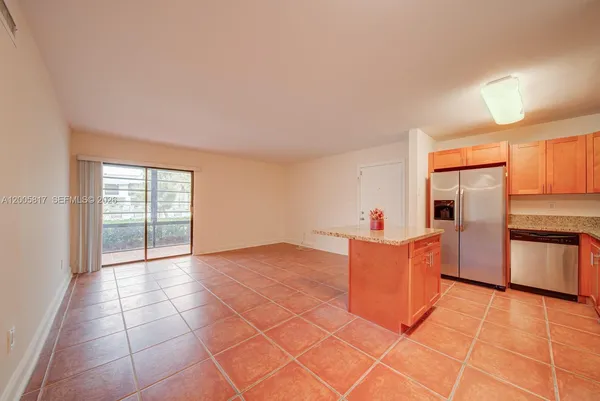 a kitchen with stainless steel appliances granite countertop a sink and cabinets