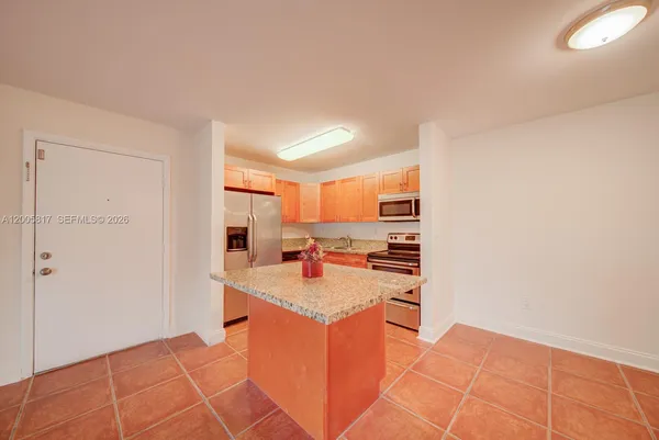 a kitchen with stainless steel appliances granite countertop a sink and a stove