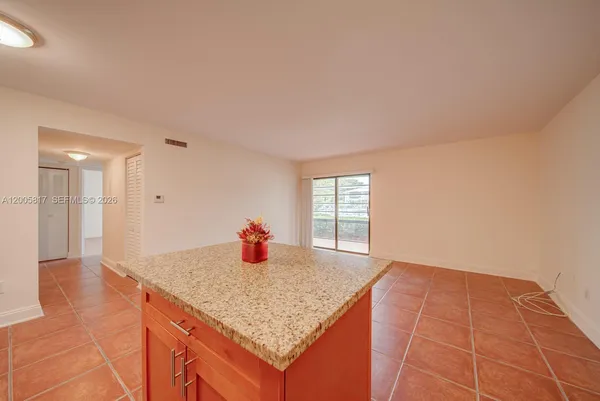 a view of kitchen with granite countertop lots of counter top space and appliances