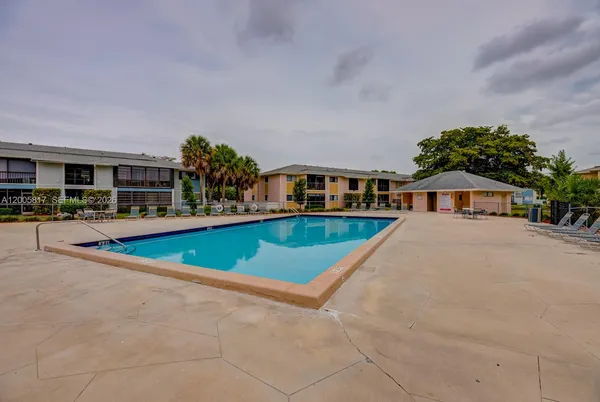 a view of an house with swimming pool and seating area
