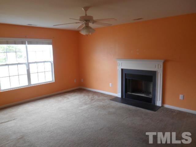 4180 Dalcross Road Raleigh, NC 27610 - Photo 5 of 12 an empty room with windows and fireplace