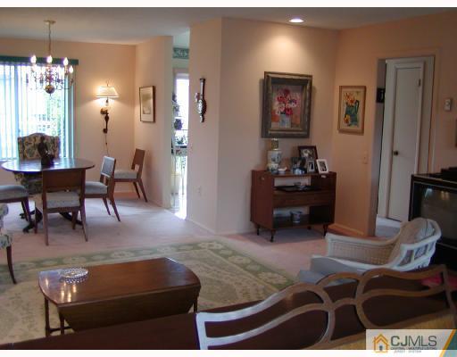 735 B Prospect Road Monroe Township, NJ 08831 - Photo 4 of 8 a living room with furniture and a chandelier