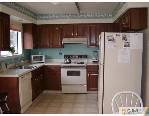 735 B Prospect Road Monroe Township, NJ 08831 - Photo 5 of 8 a kitchen with stainless steel appliances a stove a microwave and a refrigerator