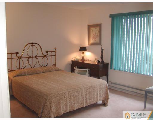 735 B Prospect Road Monroe Township, NJ 08831 - Photo 7 of 8 a bedroom with a bed and a window