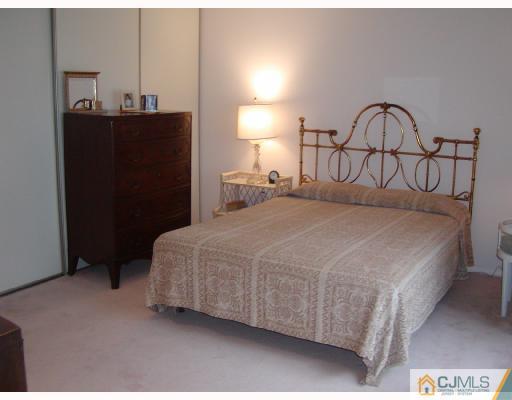 735 B Prospect Road Monroe Township, NJ 08831 - Photo 8 of 8 a bedroom with a bed and a lamp
