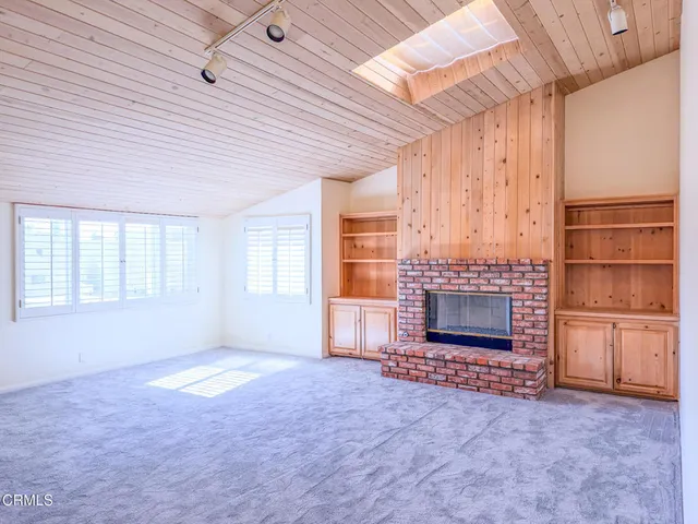 an empty room with furniture and a fireplace