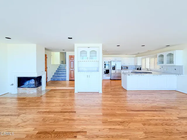 a living room with furniture and a kitchen view