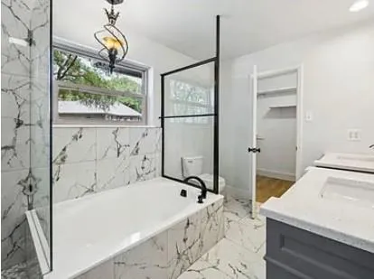 a bathroom with a bathtub and a shower