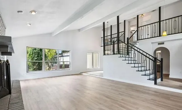a view of an entryway with wooden floor