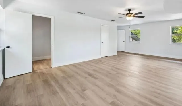 wooden floor in an empty room with a window