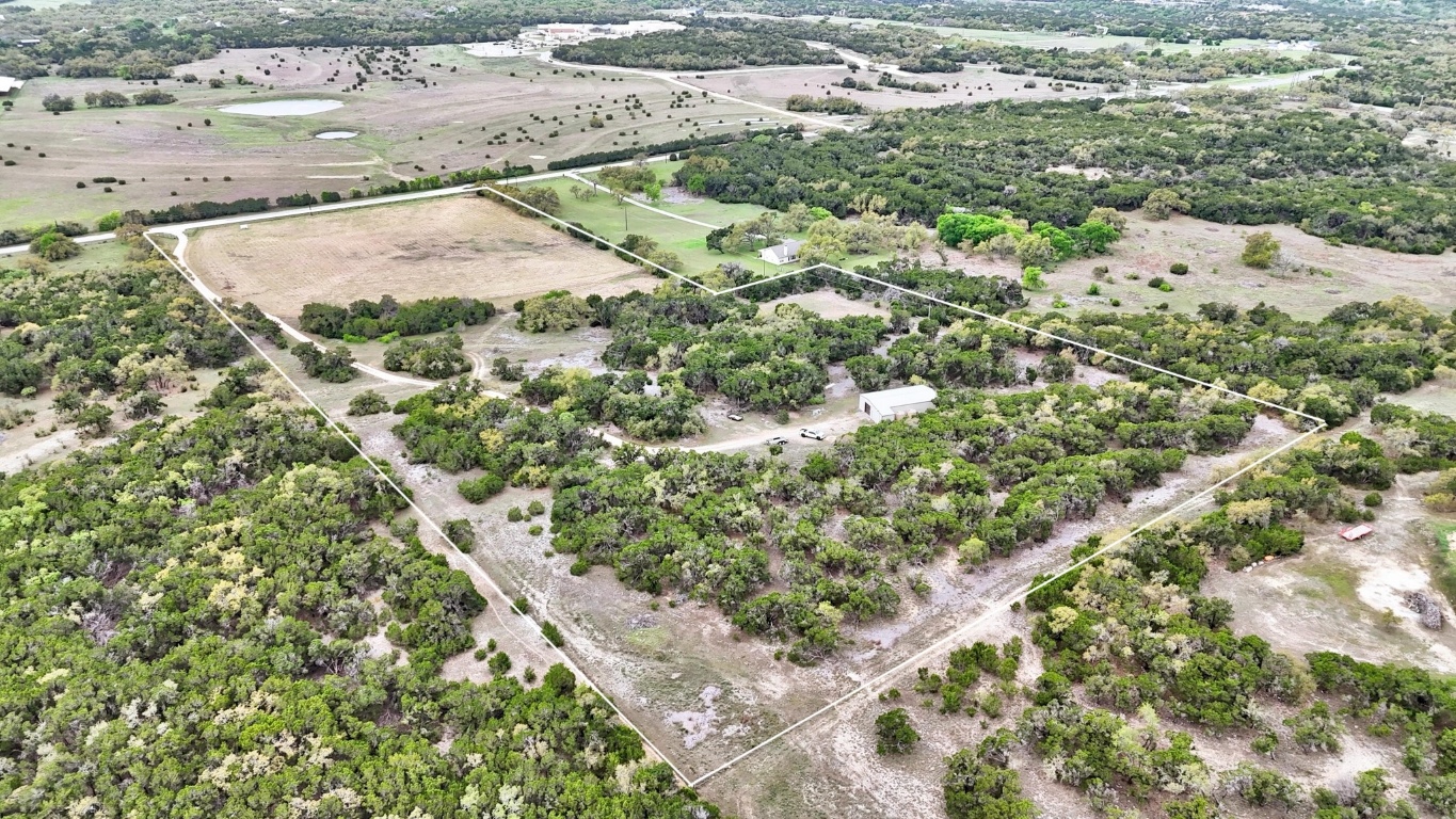 10750 Darden Hill Road Austin, TX 78737 - Photo 2 of 16 a view of a dry yard with lots of bushes