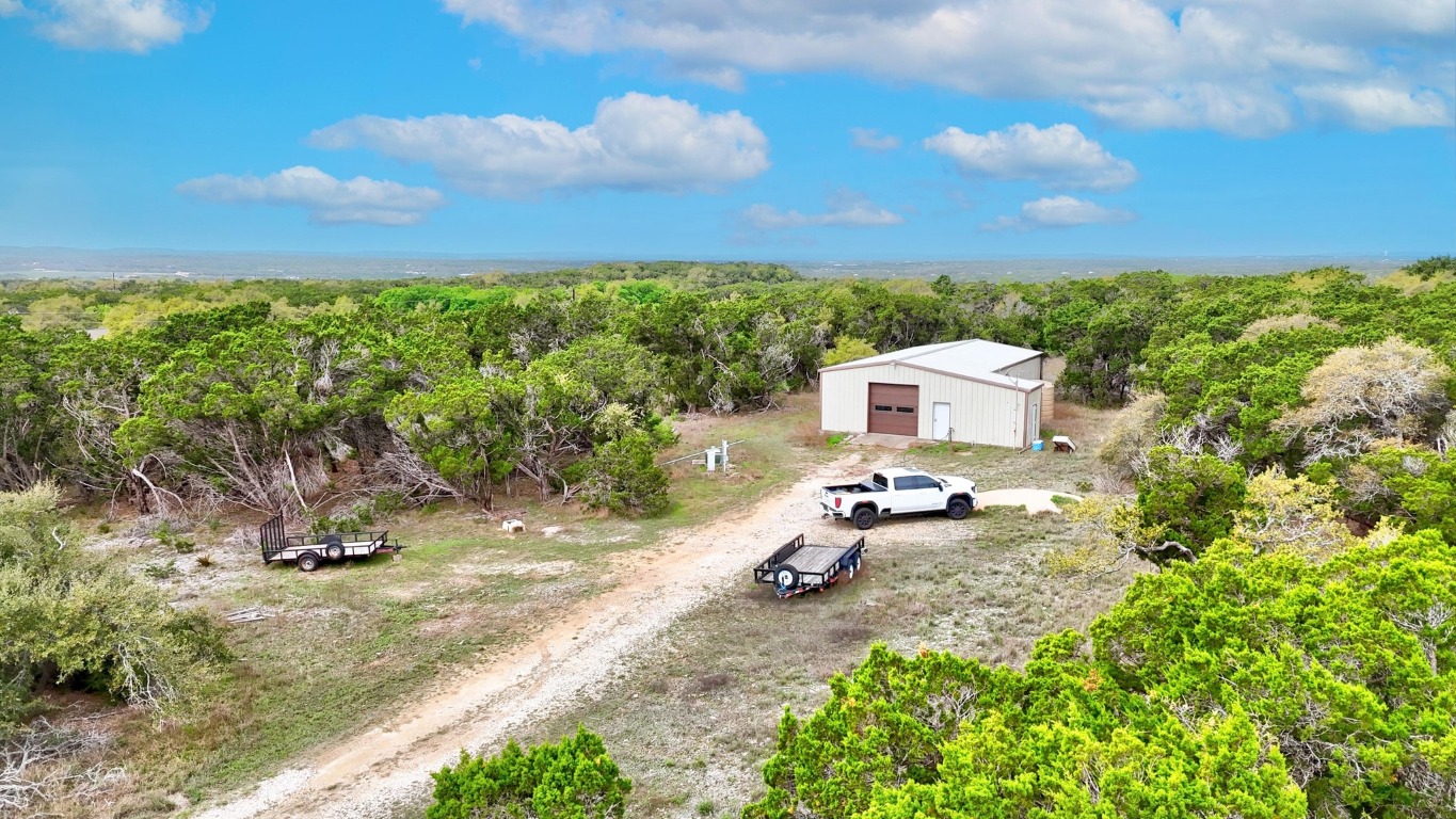 10750 Darden Hill Road Austin, TX 78737 - Photo 7 of 16 a backyard of a house with table and chairs
