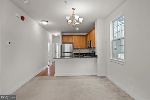 a kitchen with a refrigerator a sink and a stove