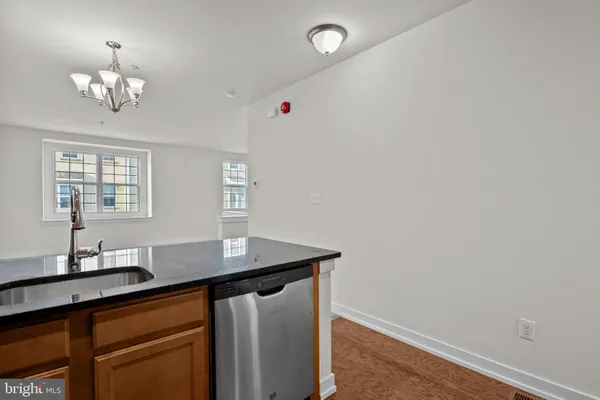 a bathroom with a granite countertop sink toilet vanity mirror bathtub and shower