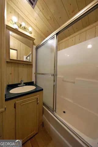 a bathroom with a sink a mirror and a shower
