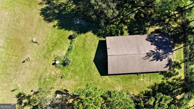 a white house with a yard and plants